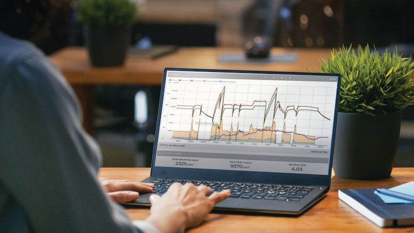 Person working on a laptop with a graph on the screen