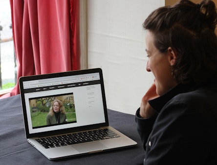 A Woman watches a video about CAT on a laptop